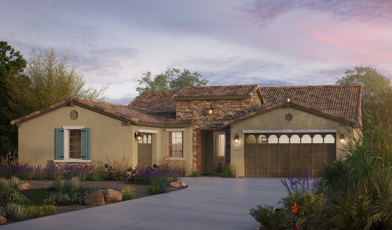 Single-story house with tan stucco and stone exterior, brown tiled roof, blue shutters, and a two-car garage. The front yard features landscaped plants, rocks, and a wide driveway at sunset.