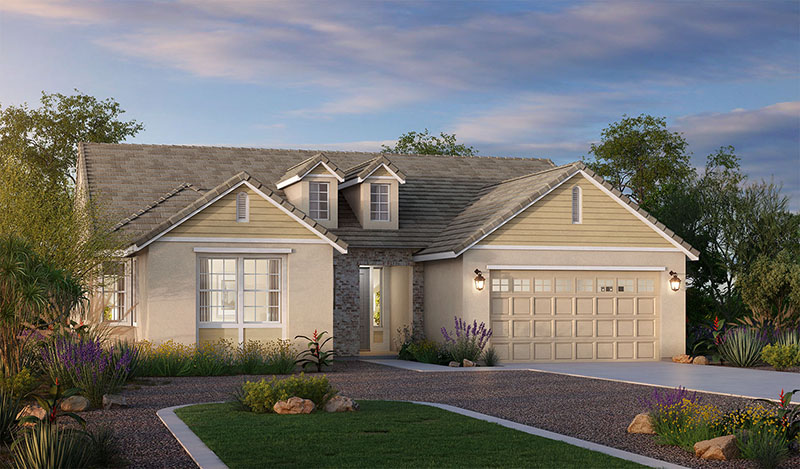 Single-story suburban house with light beige siding, stone accents, and a two-car garage. The front yard has green shrubs, flowering plants, and a curved gravel driveway under a partly cloudy sky.